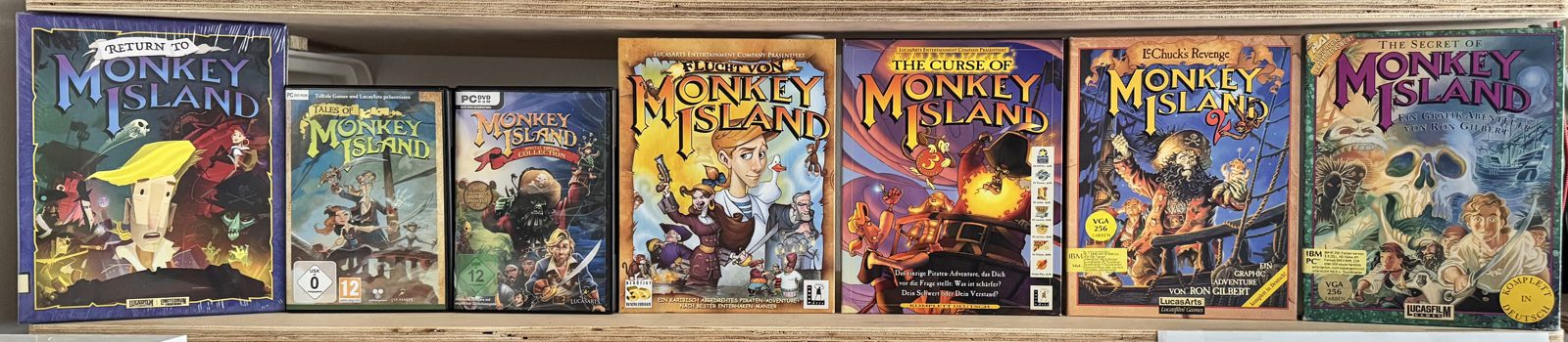 All Monkey Island games in their original boxes on a shelf
